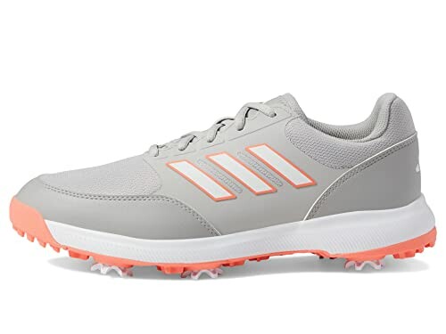 Gray and pink golf shoe with soft spikes.