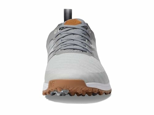 New Balance Men's Fresh Foam Contend V2 Golf Shoe - Front view of a gray sneaker with brown sole.