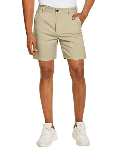 Man wearing khaki shorts and white sneakers