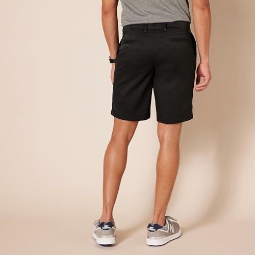 Man wearing black shorts, back view