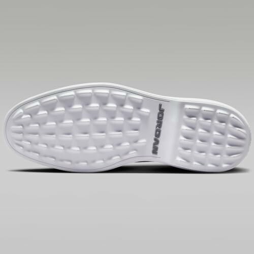 Bottom view of a white sneaker sole with textured pattern