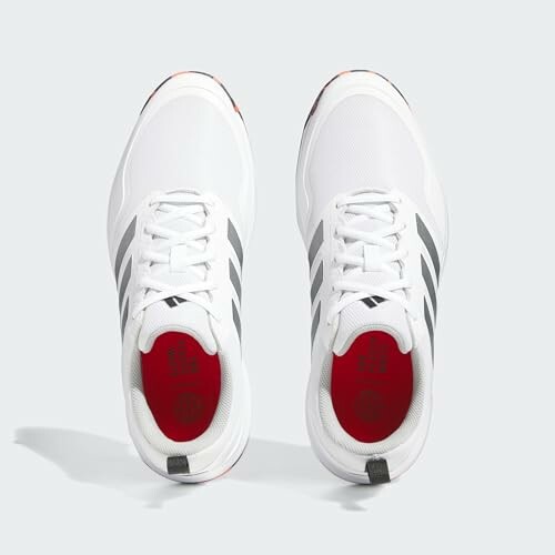 adidas mens Tech Response Spikeless 3.0 Golf Shoes - Top view of white sneakers with black stripes and red interior